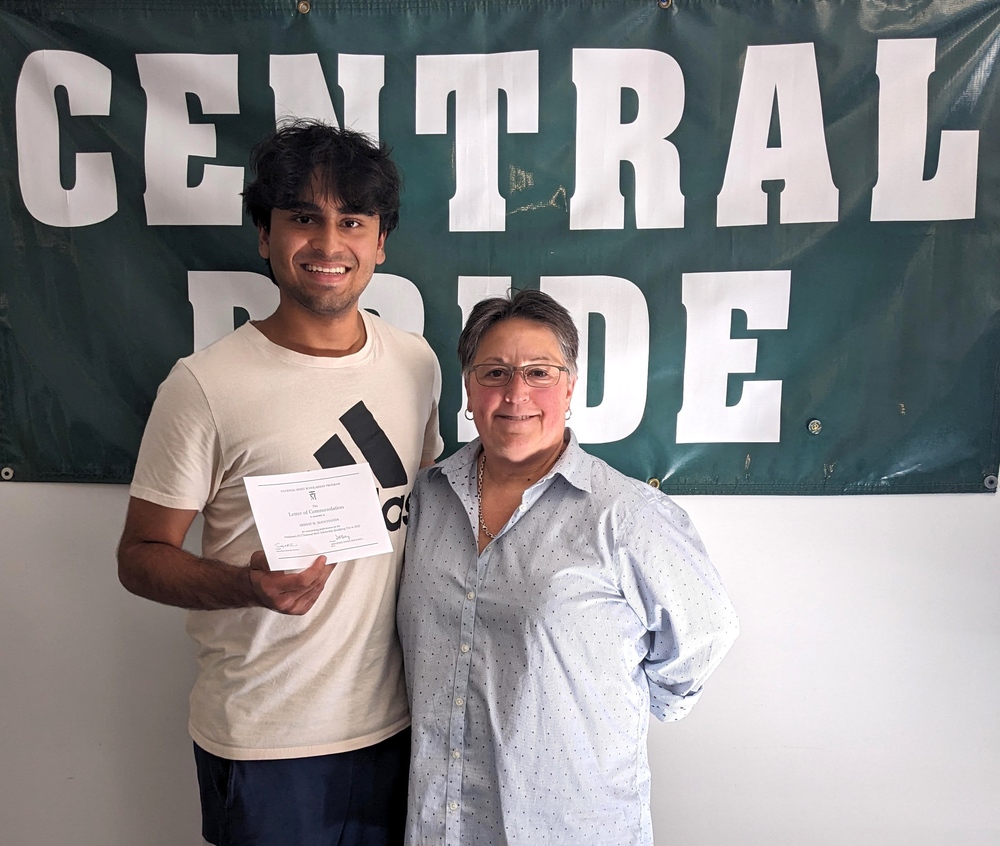 Central senior Akshay Manchanda poses with Principal Deb Roukey in front of banner reading Central Pride