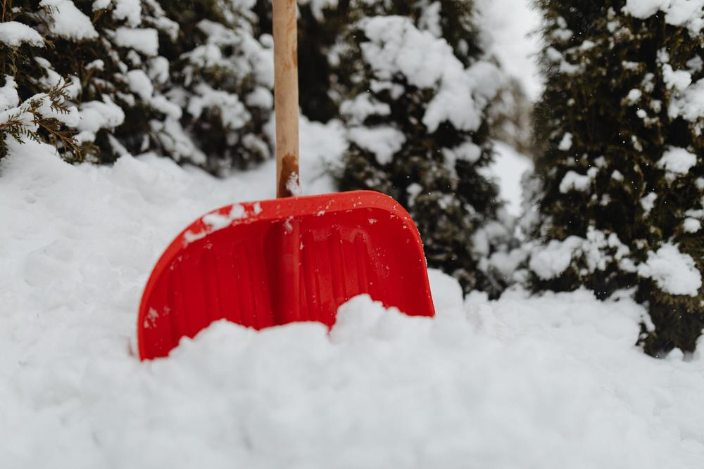 snow shovel in pile of snow