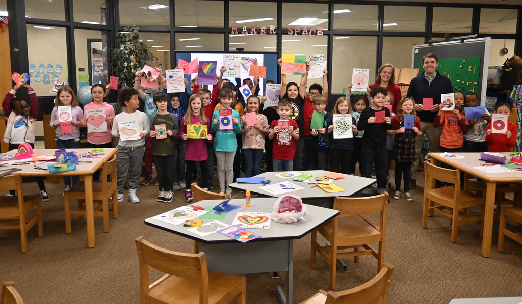 students at Smyth Road pose with valentines they made for veterans