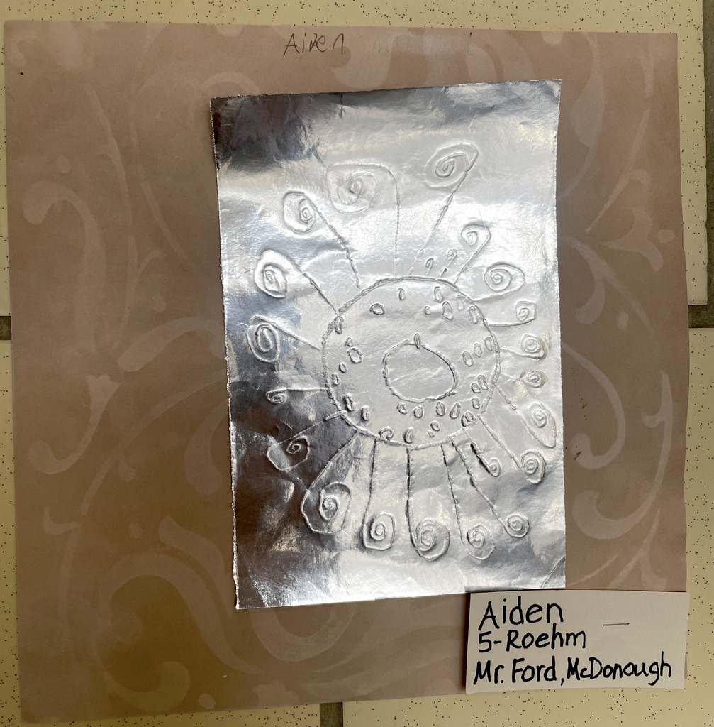 student artwork punched foil sun design by Aiden Grade 5
