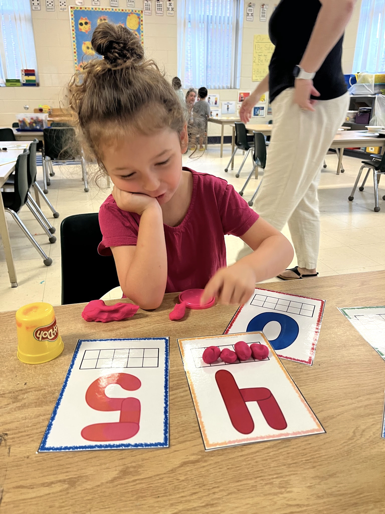 student in Blast Off to Kindergarten program uses Pla-Doh on number blocks